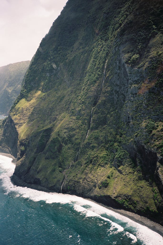 A breathtaking aerial view of Molokai's lush cliffs and pristine shoreline, Hawaii.