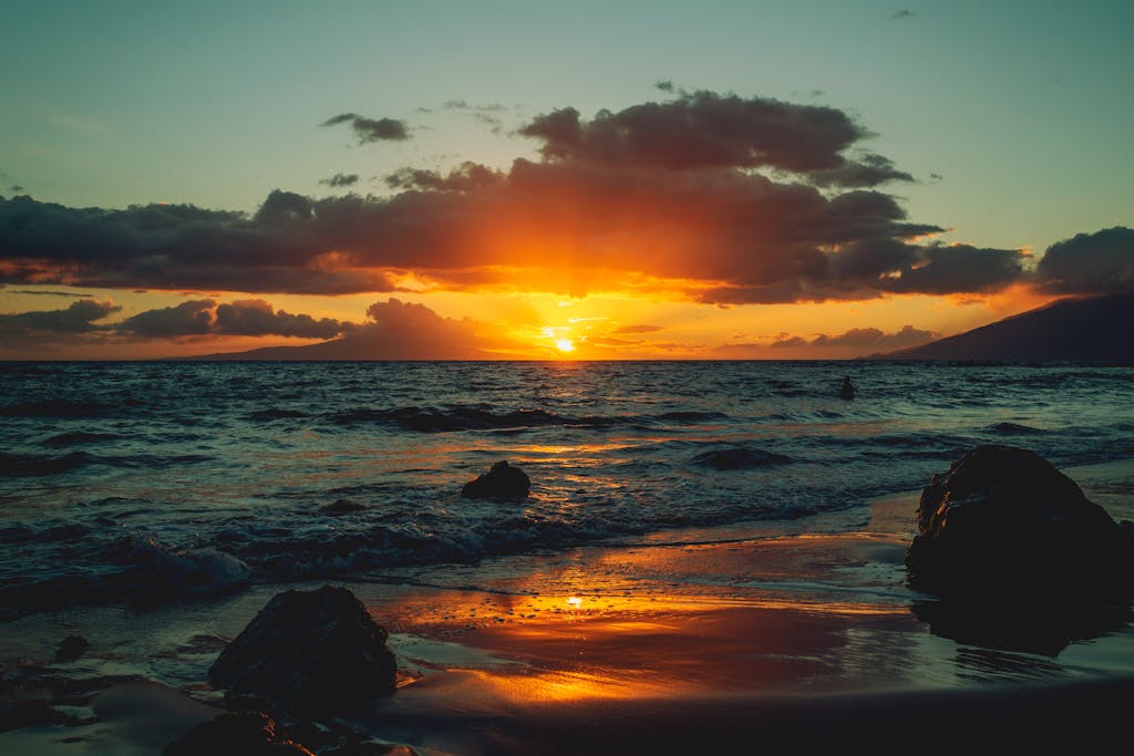 Capture of a breathtaking sunset over the Kula coastline with vibrant skies and serene waves.