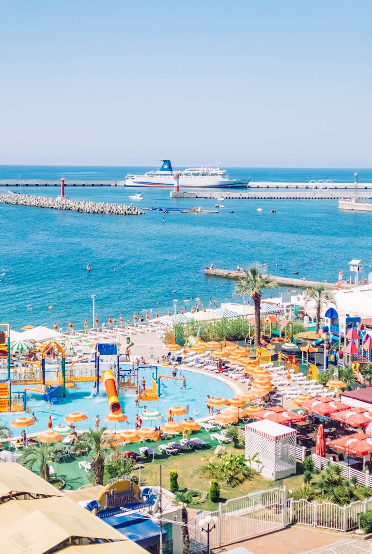 Colorful resort in Sochi with a pool and sea view, perfect for a sunny vacation.
