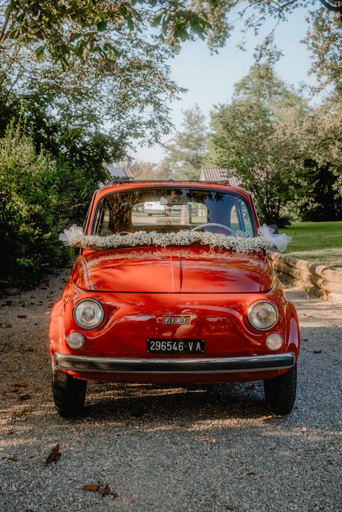 Charming red Fiat 500 adorned for a wedding, captured outdoors in Gallarate, Italia.