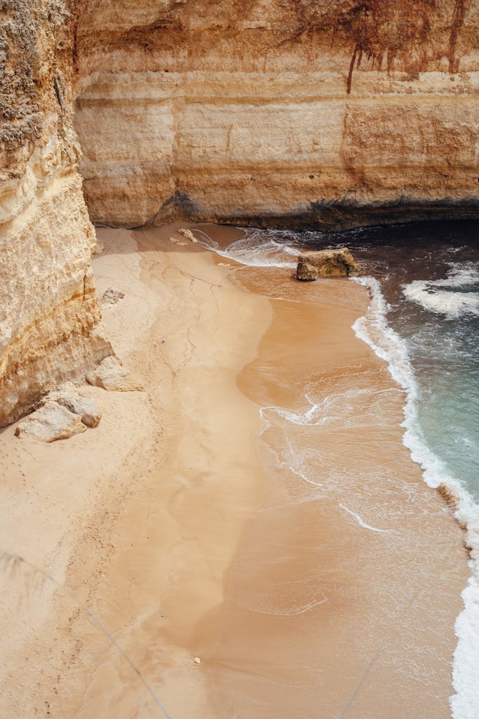 Beautiful aerial view of Algarve beach with sandy shoreline and cliffs in Portugal.